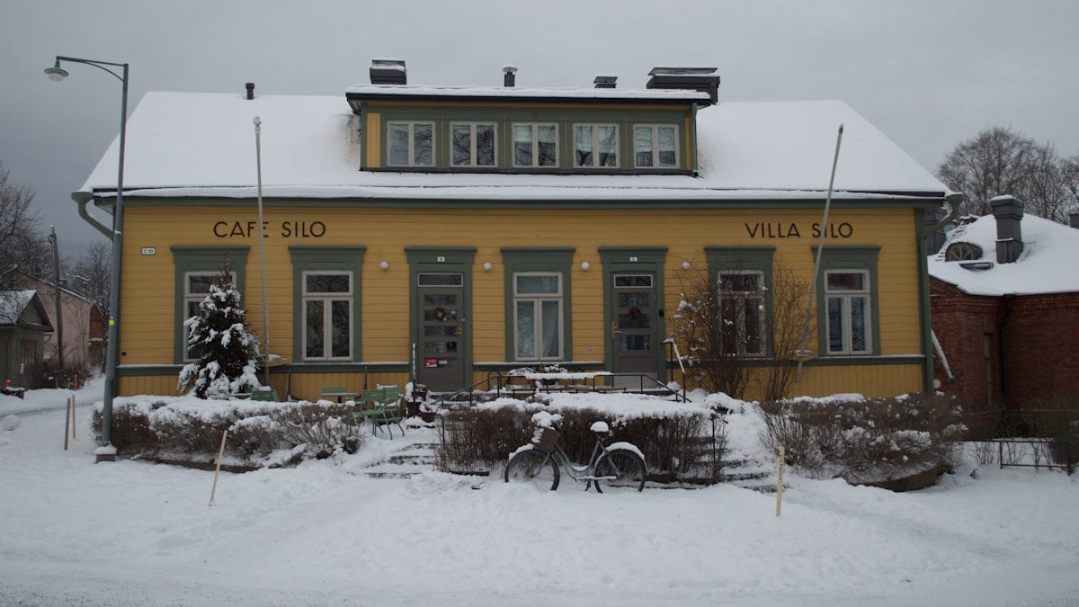 a yellow building with a bicycle parked in front of it